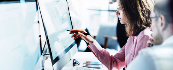 woman and man working on computer