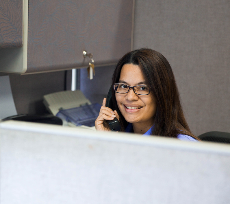 office-worker-smiling-3-cs-right office worker on phone in cubicle