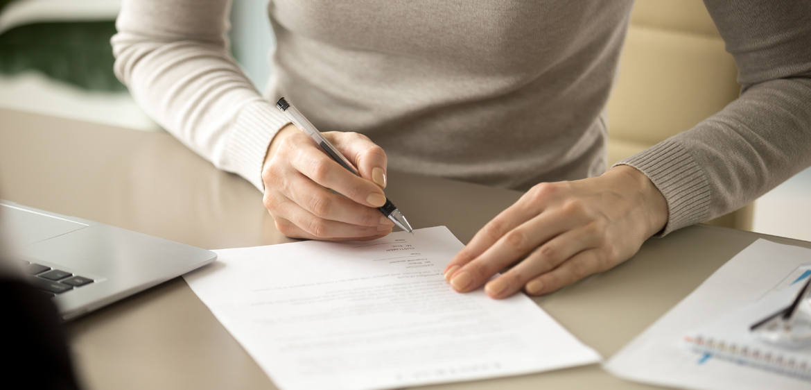 woman signing document