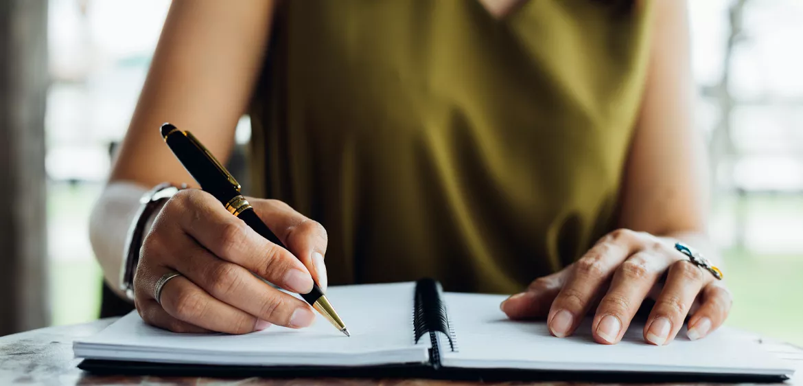 woman writing in notebook