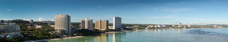 land scape of guam beach, hotel and buildings along seashore, panorama view of beach