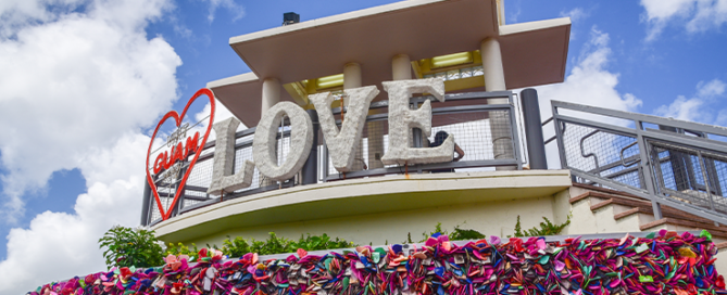 Two lovers point look out view point with Love,GUAM, Red Heart sign: Close up view with many locks