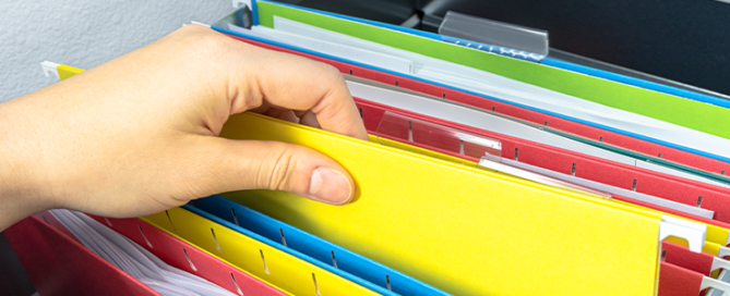close up of hand working on file cabinet